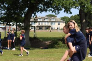 girls playing in the fields at the front of Ballard School